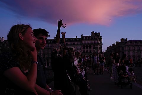 Paris Olympics: People watch outside the Tuileries garden as the cauldron is extinguished ahead of the 2024 Olympics closing ceremony
